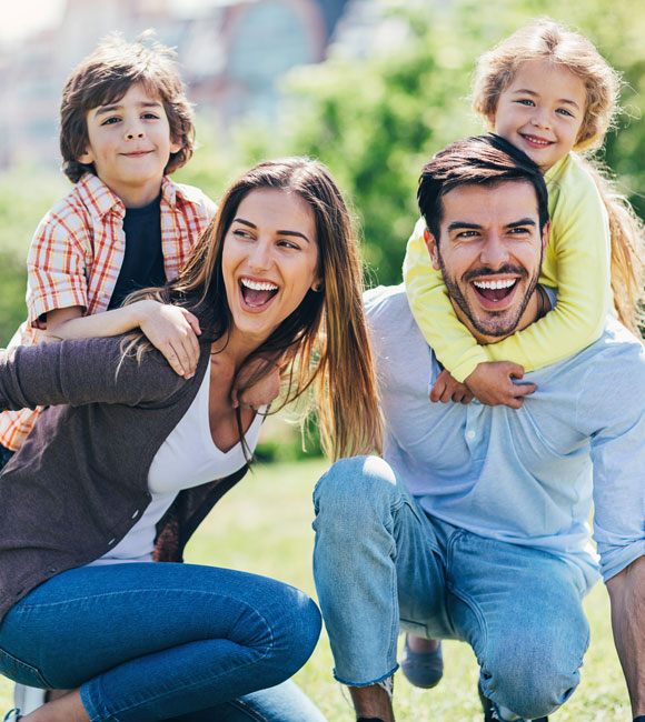 family of four playing outside together